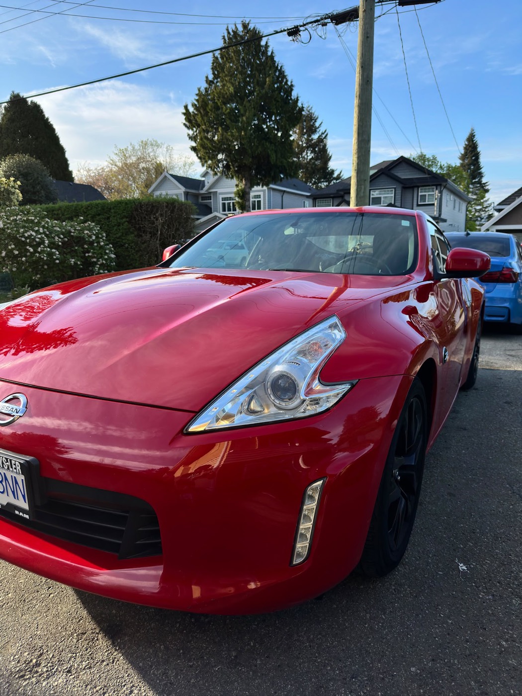 Red Nissan 370Z, rear quarter, after a deep clean exterior detail